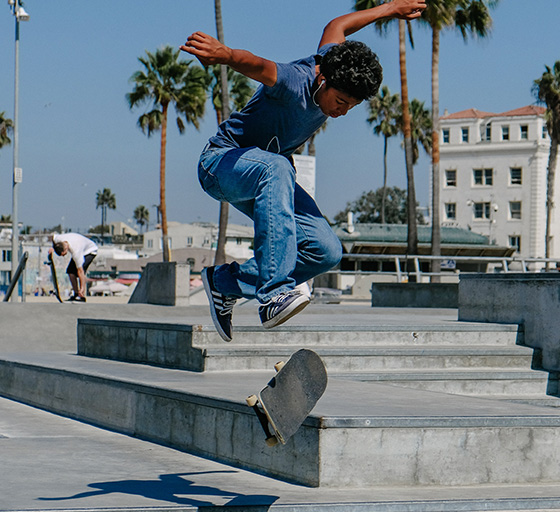 Skateboarder does tre-flip of ledge